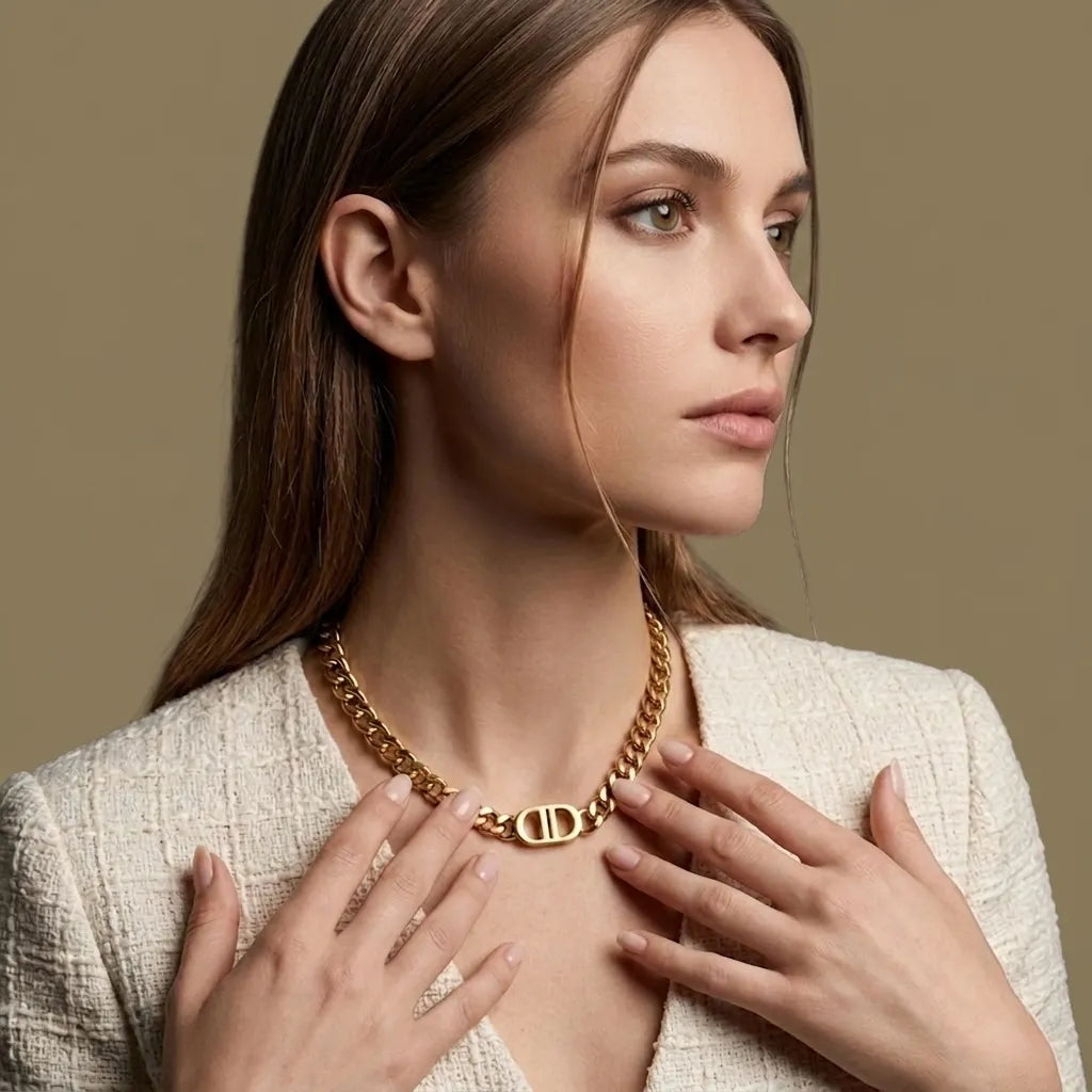Woman wearing a gold necklace with a beige background