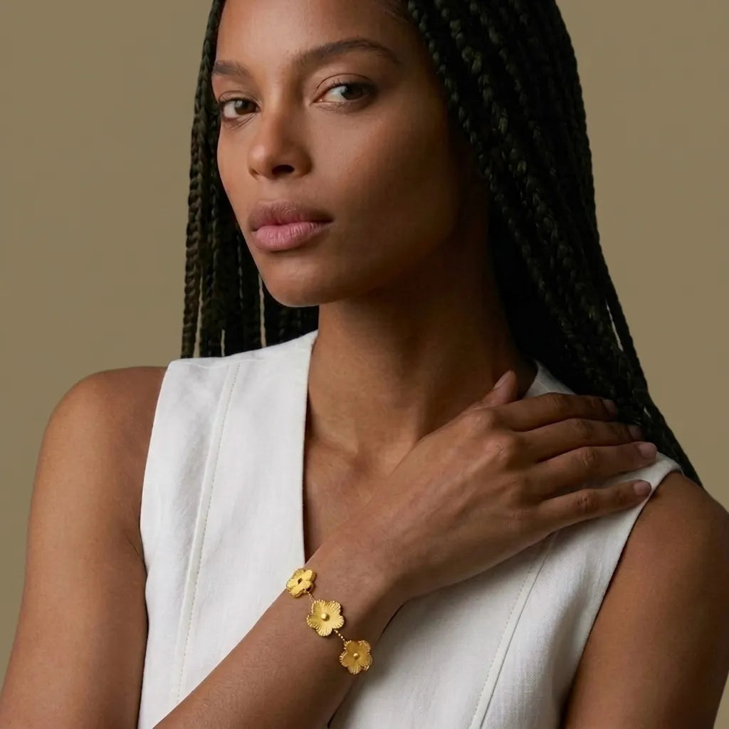 Woman in white wearing the gold Forever Flowers harvest bracelet, waterproof jewelry by Raline Bergemann