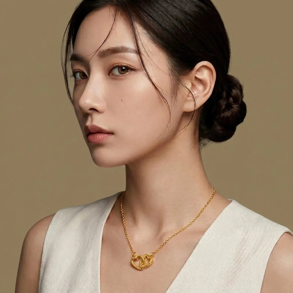 Woman wearing a gold necklace against a beige background