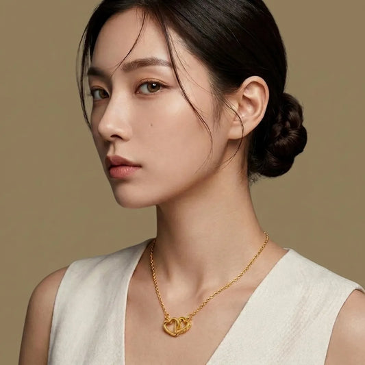 Woman wearing a gold necklace against a beige background