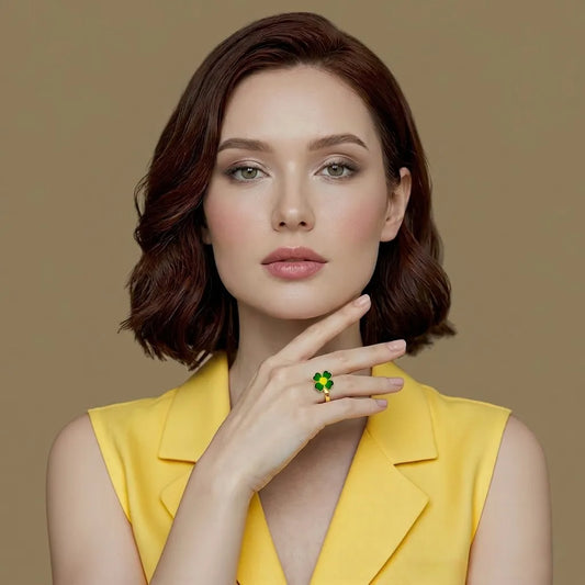 Woman in a yellow top wearing the green enamel Glücksbringer clover ring, gold-finish keepsake jewelry