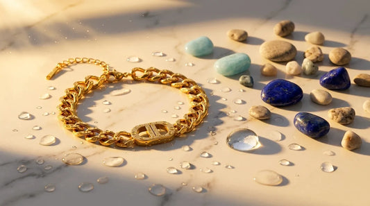 Raline Bergemann 18K gold PVD jewelry Switzerland — waterproof gold bracelet tarnish-free on marble with water droplets