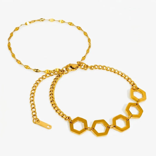 Gold chain bracelet with hexagonal links on a white background