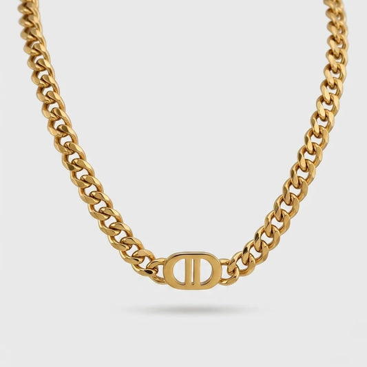 Gold chain necklace with a logo on a light gray background