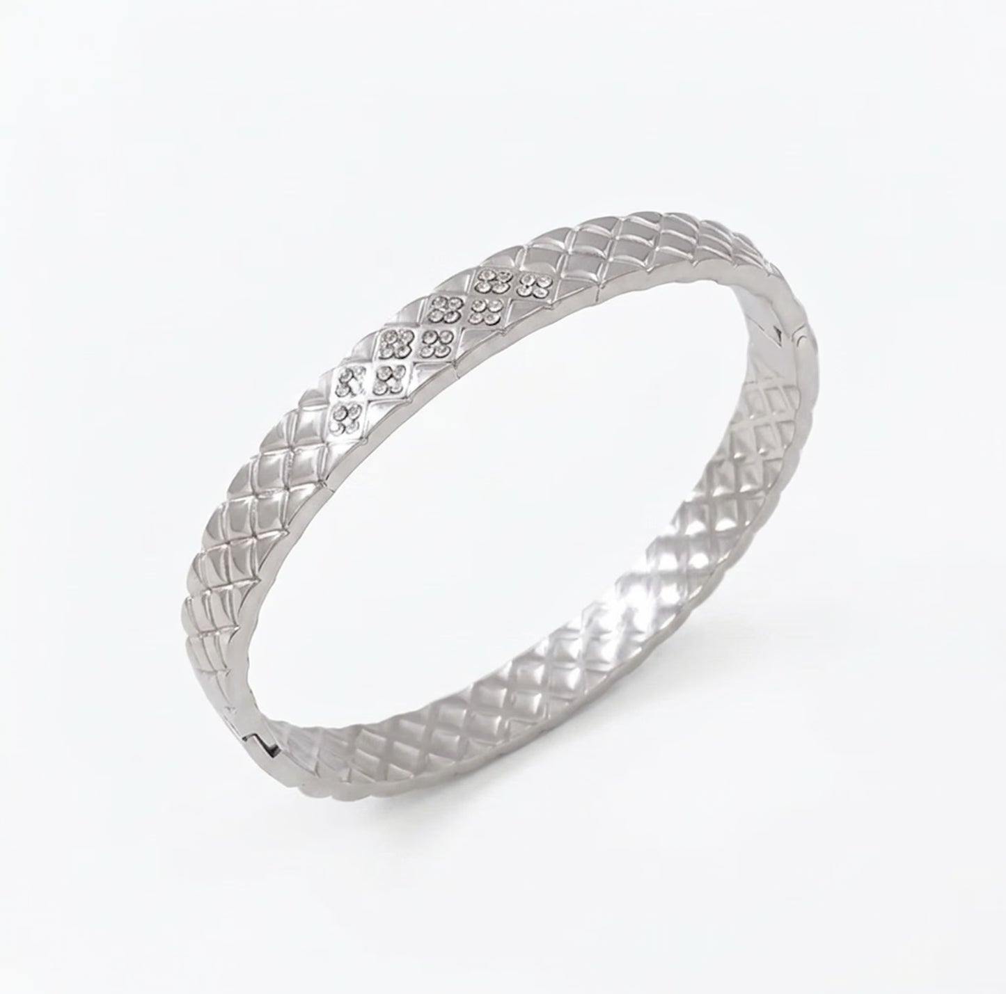 Silver bracelet with cushion design on a white background