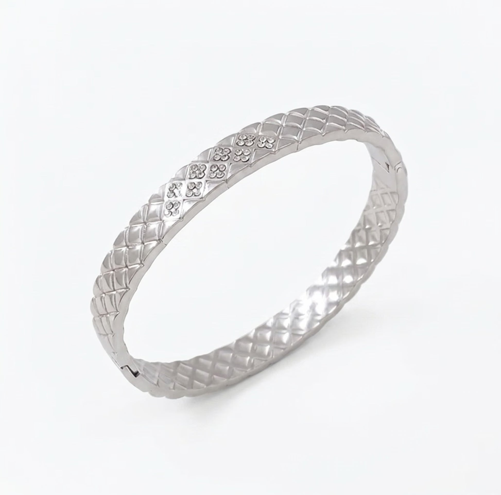 Silver bracelet with cushion design on a white background