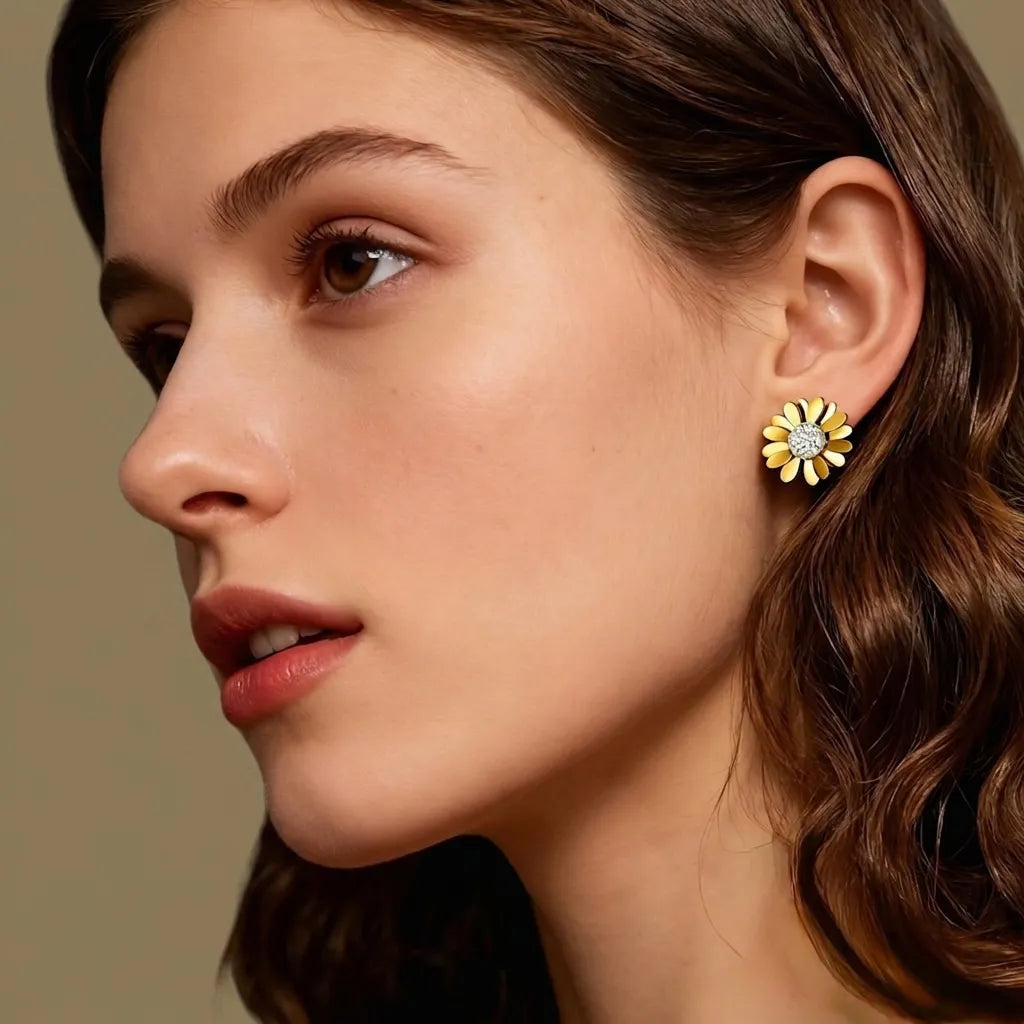 Close-up of a woman wearing a sunflower-shaped earring against a neutral background