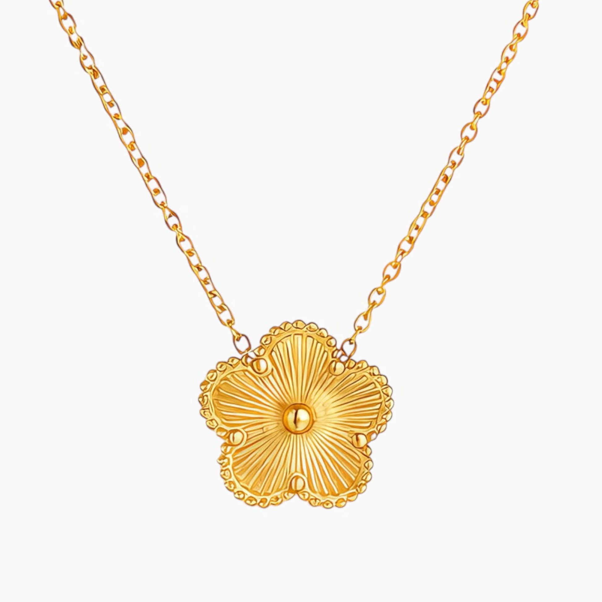 Gold necklace with a floral pendant on a white background