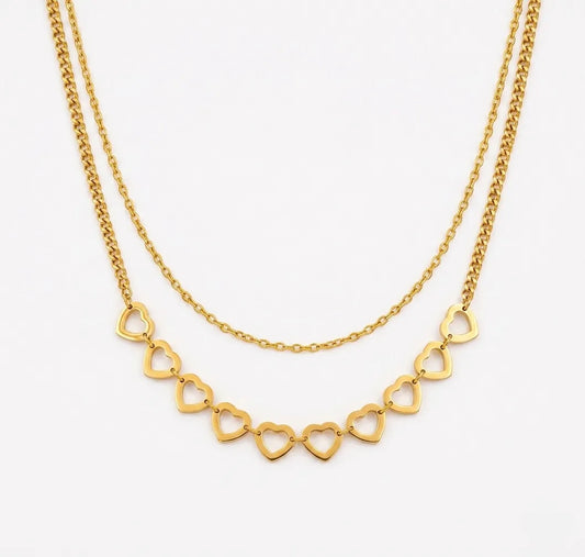Gold necklace with heart-shaped links on a white background
