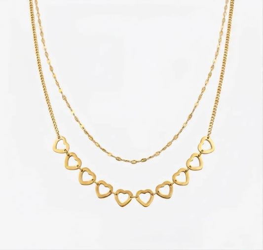Gold necklace with heart-shaped links on a white background