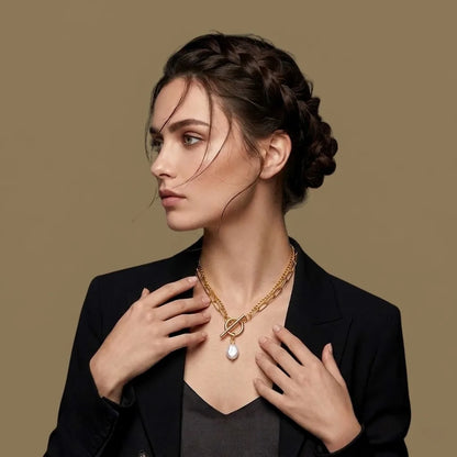 Woman wearing a gold necklace with a pendant against a brown background