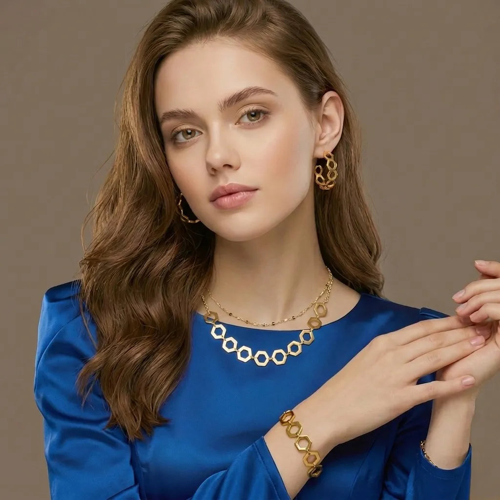 Woman wearing the gold hexagon geometric jewelry set, waterproof necklace, bracelet, and earrings
