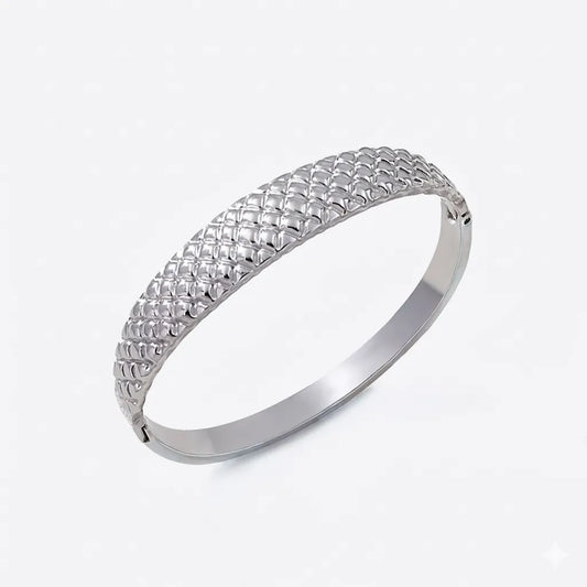 Silver bracelet on a light gray background