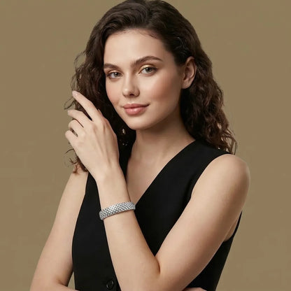 Woman in black wearing the silver quilted Lumière bangle, waterproof jewelry