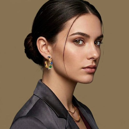 Woman wearing colorful earrings against a beige background