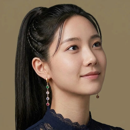 Woman with braided hair wearing multicolor crystal drop earrings, waterproof jewelry