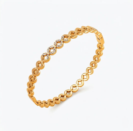 Gold bracelet with round diamond accents on a white background