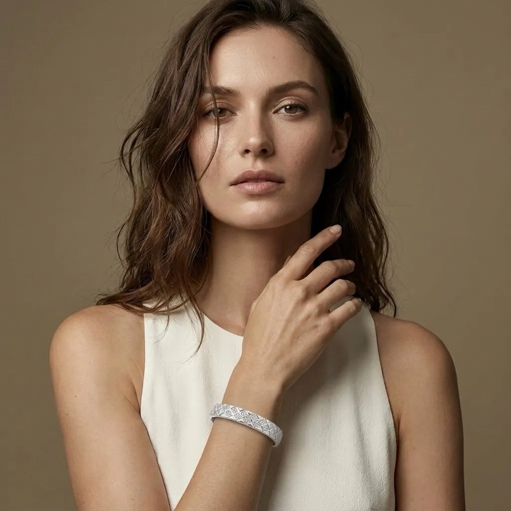 Woman in white wearing the silver Sérénité cushion bangle, waterproof jewelry
