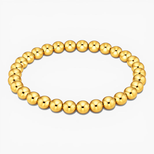Gold beaded bracelet on a white background