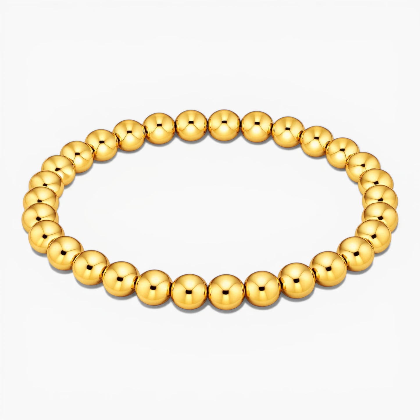 Gold beaded bracelet on a white background