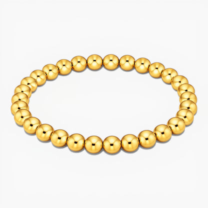 Gold beaded bracelet on a white background