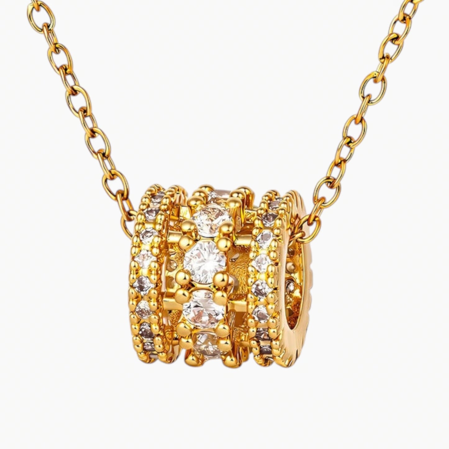 Gold necklace with multiple rings and diamonds on a white background