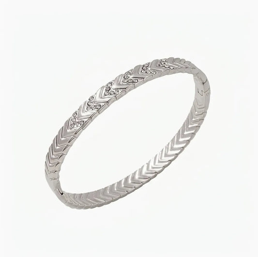 Silver bracelet with V pattern intricate design on a white background
