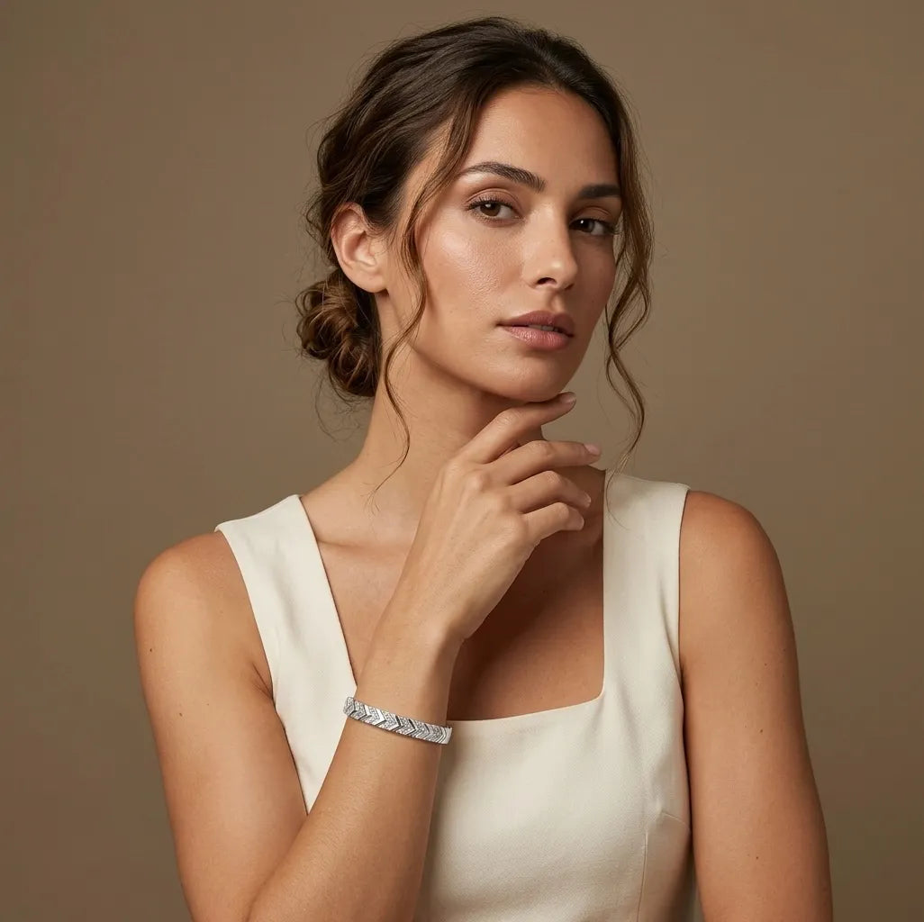 Woman in white wearing the silver Victoire geometric bangle, waterproof jewelry