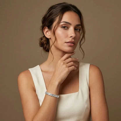 Woman in white wearing the silver Victoire geometric bangle, waterproof jewelry